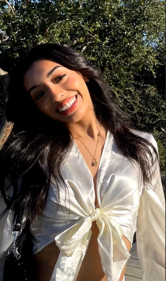 Aleena De Los Rios smiling in an outdoor portrait.
